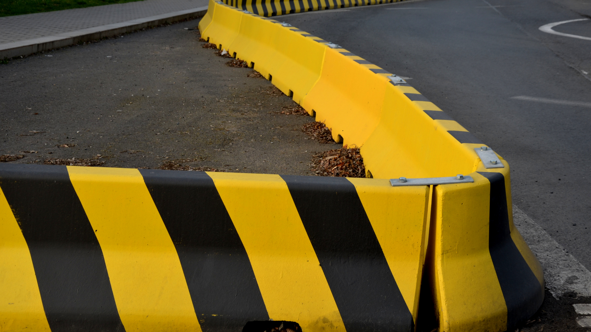 Roadside crash barriers and energy-absorbing safety systems